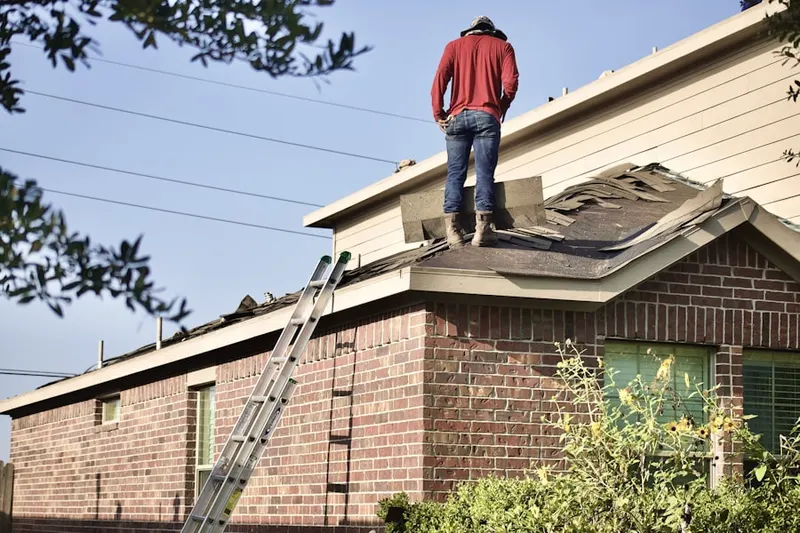 Professional roofer working on a residential roof in Rolling Green